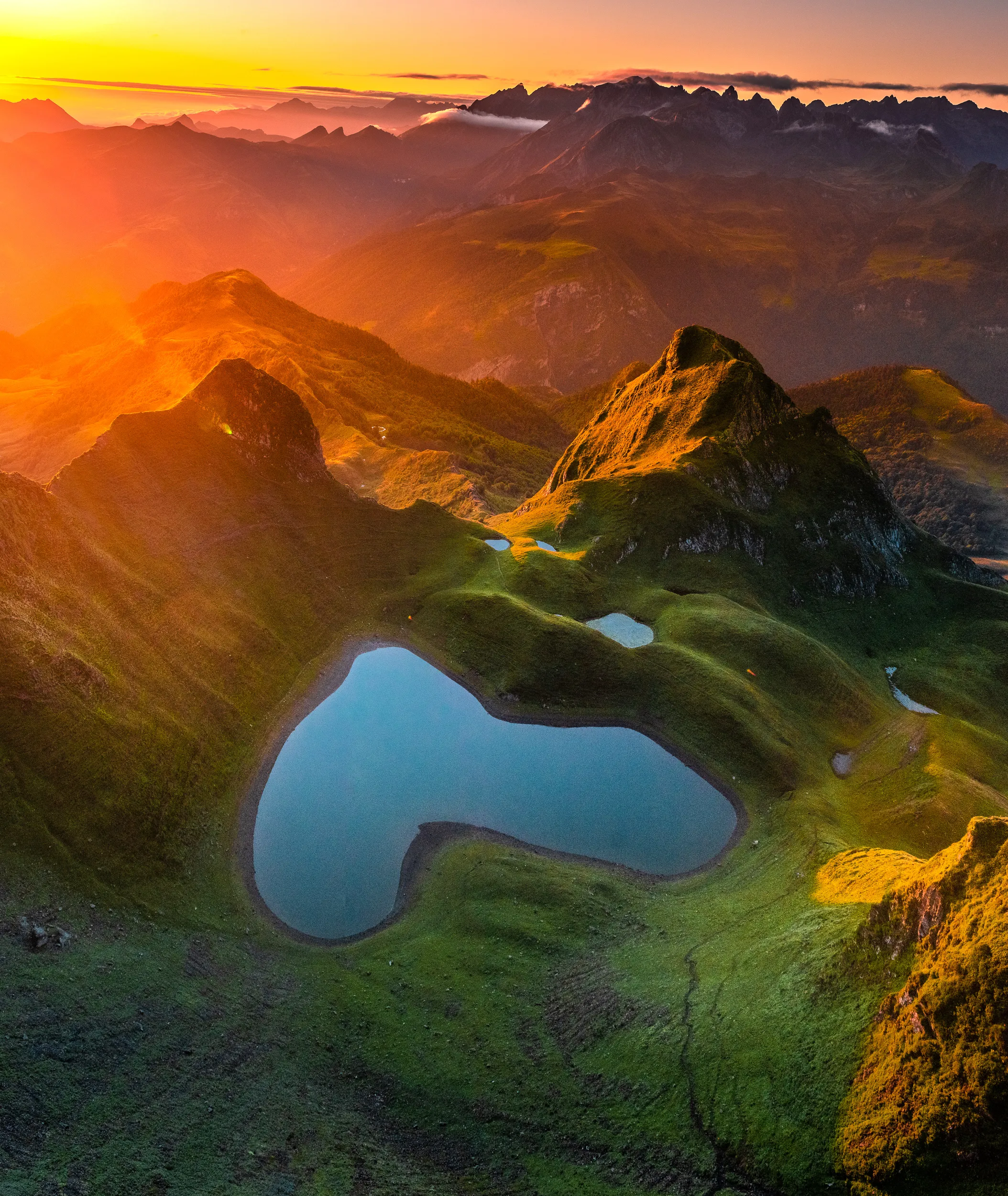 Le lac du Montagnon en forme de cœur, baigné de lumière dorée au pied du pic du Montagnon d'Iseye, vallée d'Ossau